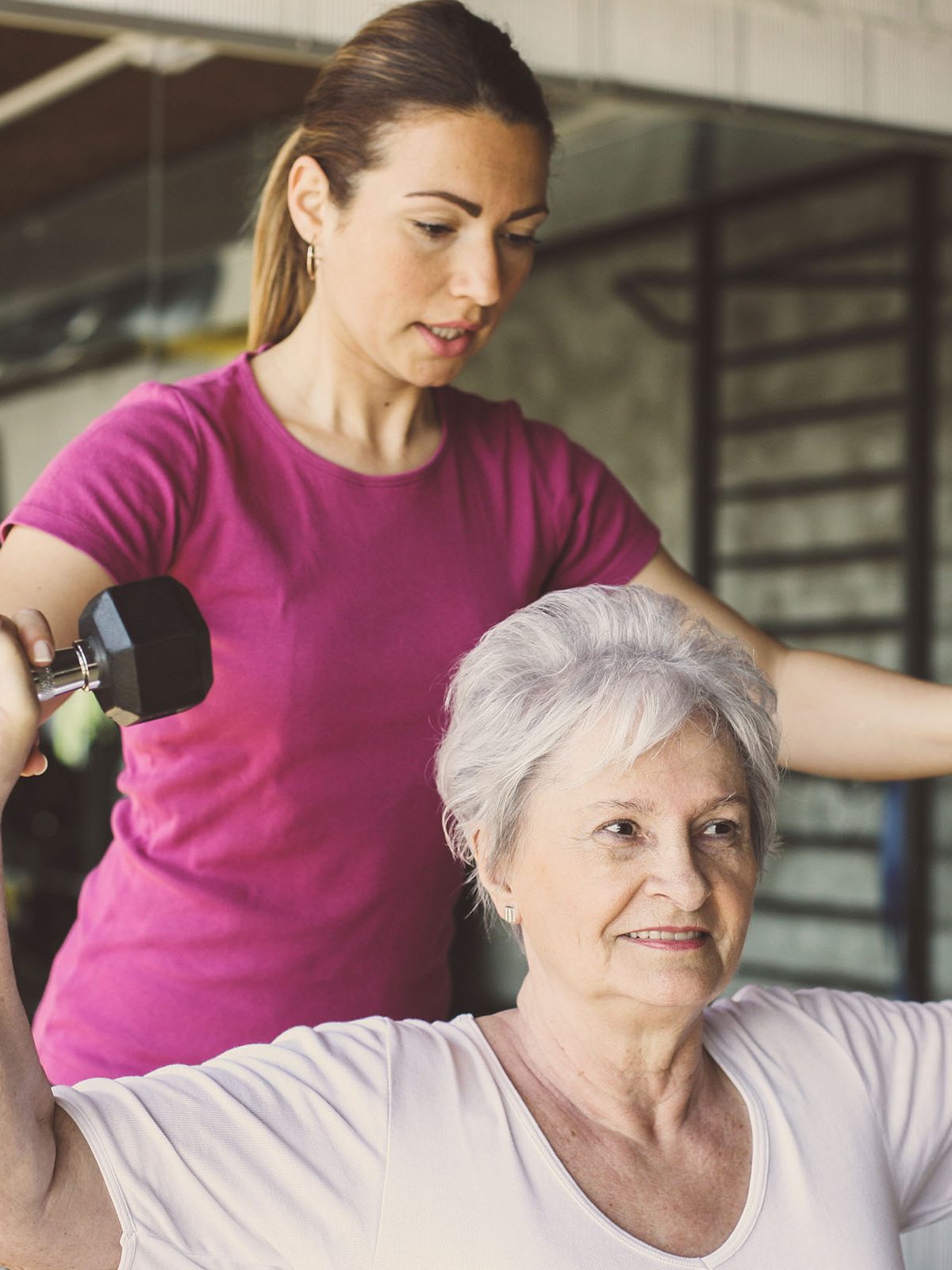 Women working out at a wellness center with a trainer